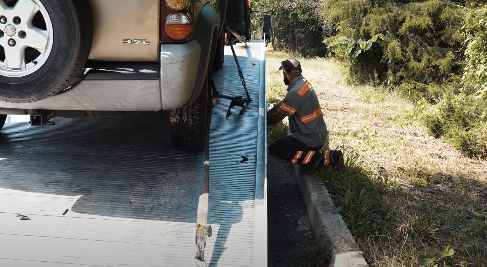 Professional flatbed tow truck loading a vehicle safely