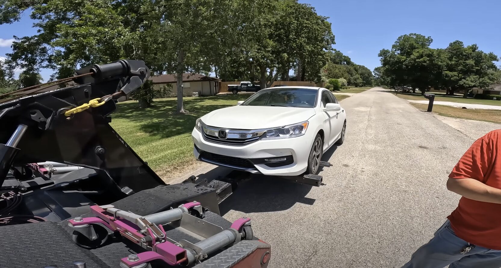 Professional accident vehicle recovery and transport Accident recovery scene showing damaged vehicle being prepared for safe transport on flatbed tow truck